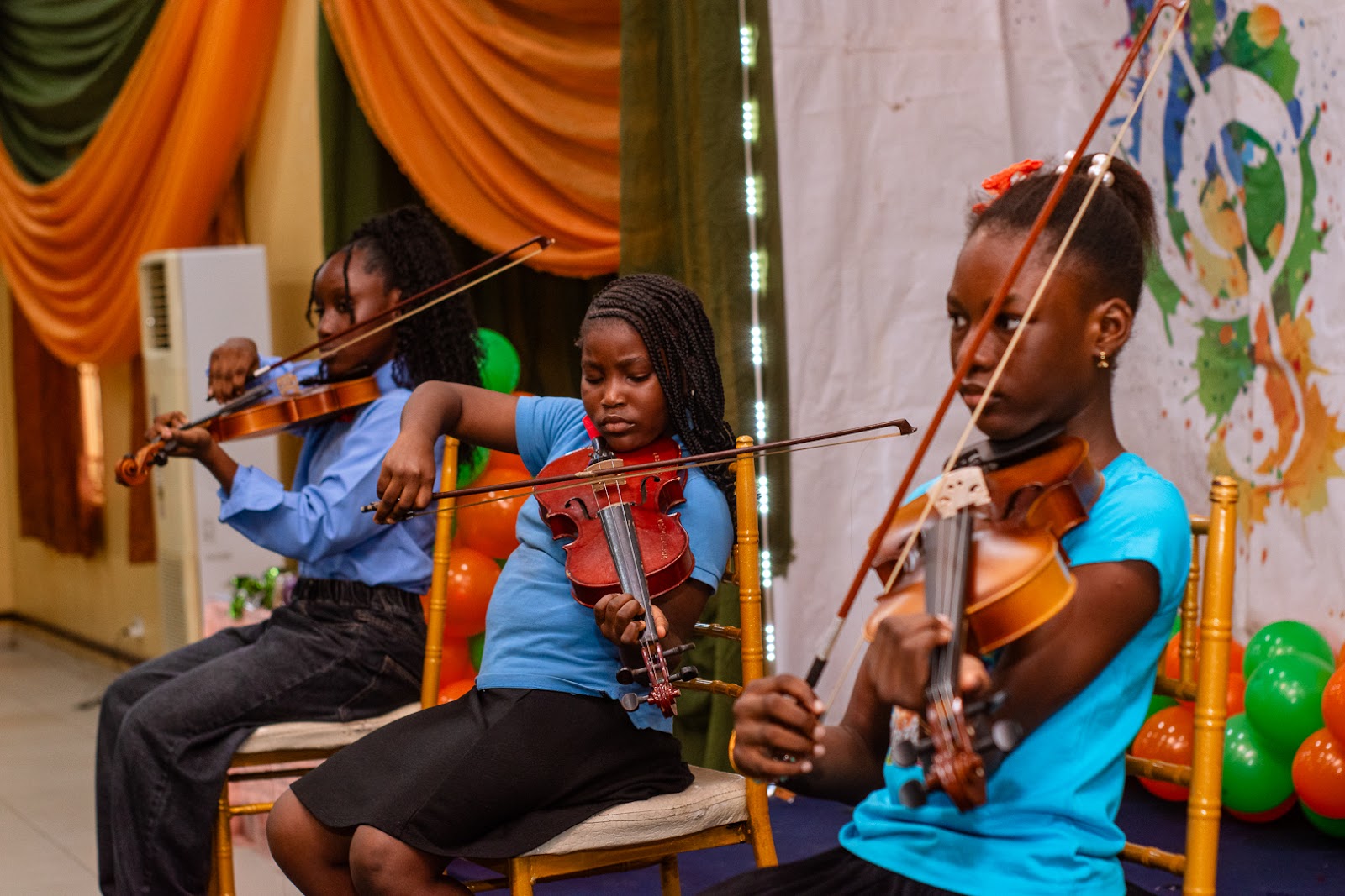 Citacad pupils learning to play violins